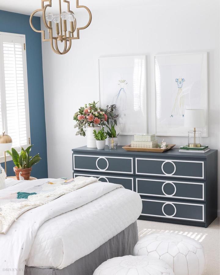 Navy and white geometric trimmed bedroom dresser from @drivenbydecor with floral accents and modern decor.