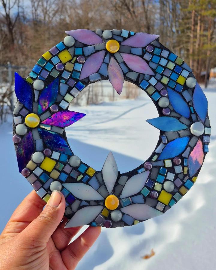 Purple and blue floral mosaic wreath crafted with glass tiles and beads from @art_by_shehlamir. Handheld colorful circular tile decor.