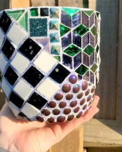 Glossy green and purple glass tiles with black and white checkerboard planter from @amberjoycreativefacilitator. Unique textured mosaic with rounded brown accents.