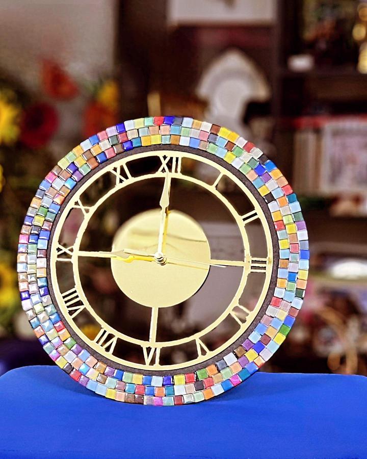 Colorful ceramic tile mosaic clock with Roman numerals from @nsjcreates bright and cheerful handmade craft idea.