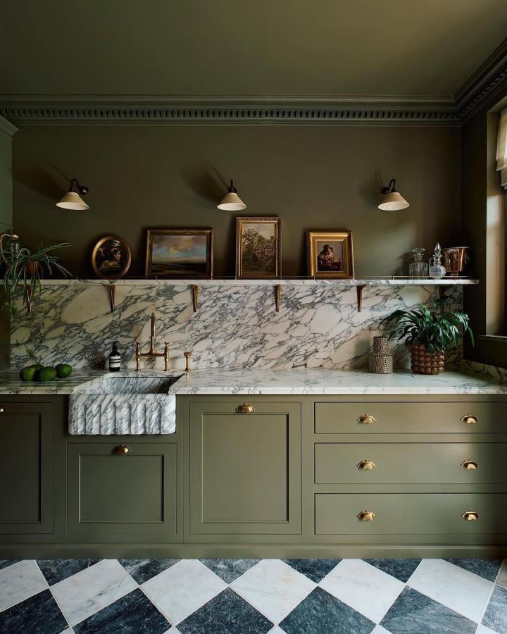 Olive cabinetry and white marble open shelf from @home_decor_daily with brass brackets and classic framed art. Elegant kitchen styling.