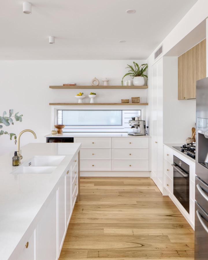 Natural wood floating shelves kitchen design from @styledbyluee with white cabinets and warm accents. Bright and airy space.