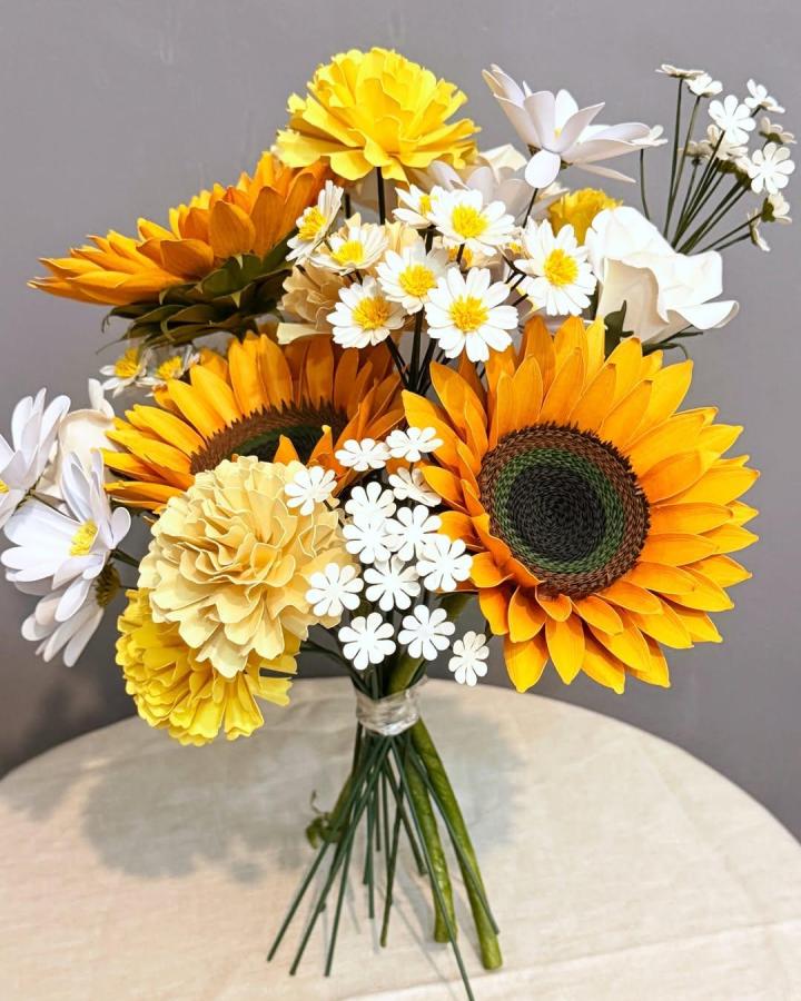 Bright yellow and white handmade paper flower bouquet from @bloomingdalecollections.ph with sunflowers and daisies on green stems.