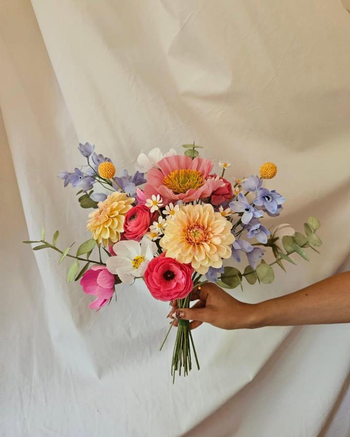 Pastel and bright mixed paper flower bouquet from @paper.lene. Handheld arrangement with detailed petals and foliage.