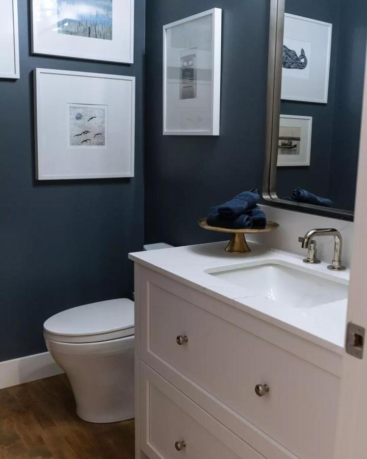 White Shaker Style Vanity Bathroom Sink with Brass Tray and Navy Walls from @noverohomes Stylish compact storage and decor combination.