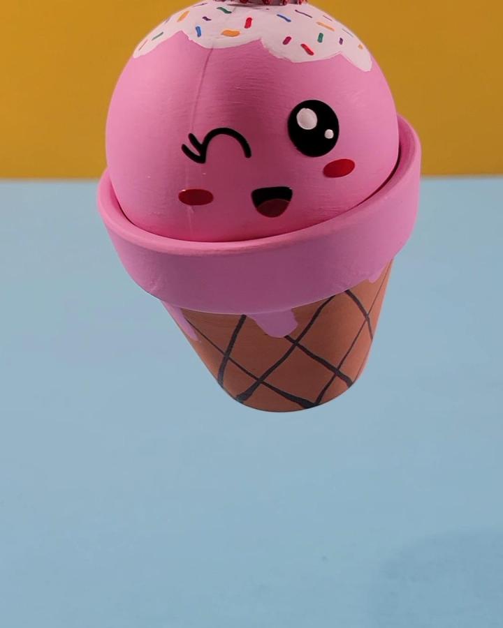Pink and brown clay pot painted like a kawaii ice cream cone with sprinkles from @kandf.design. Cute summer craft idea.