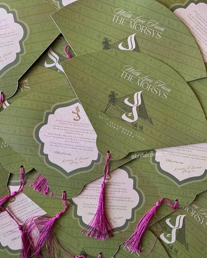 Olive green scalloped wedding fans from @bridalcreations_. Magenta tassels and botanical lettering personalize this handmade ceremony detail.