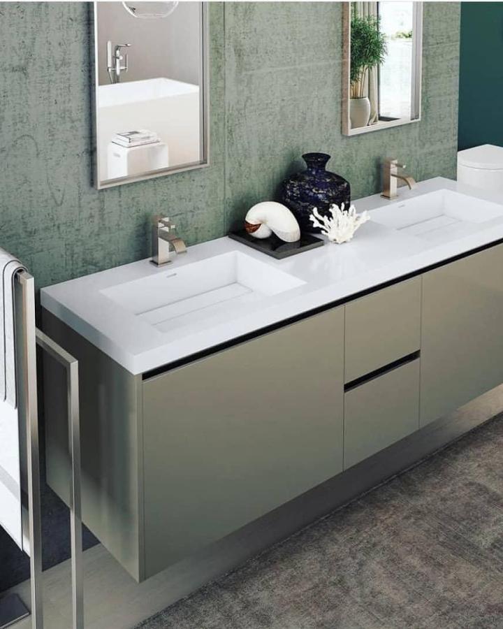 Sage green double sink bathroom vanity from @focalpointhardware. White countertop features twin rectangular basins.