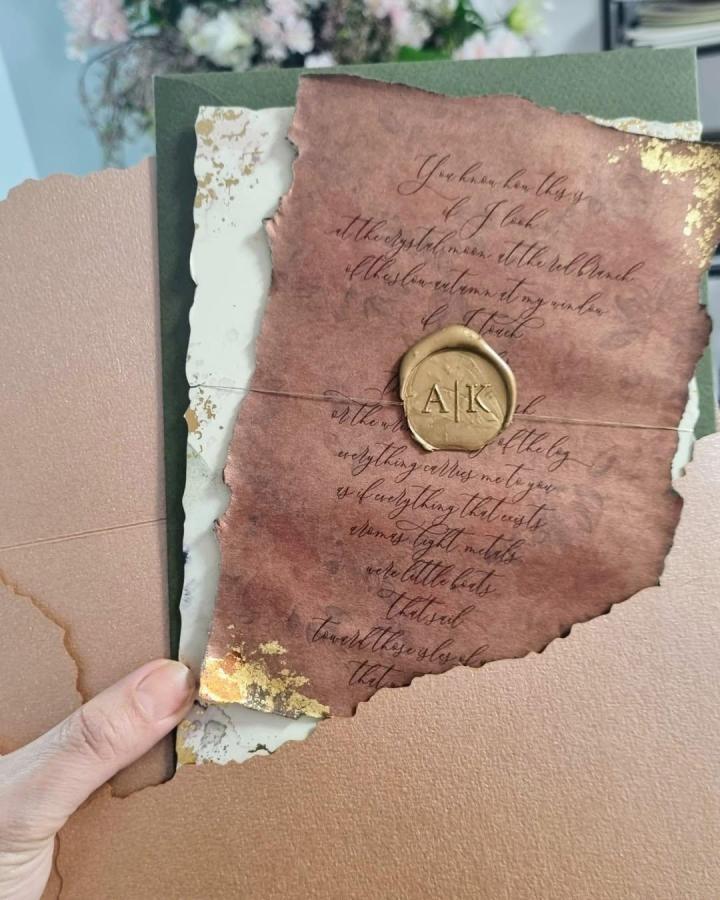 Mauve torn-paper invitation from @redgrasscy. Gold wax seal and handwritten calligraphy.