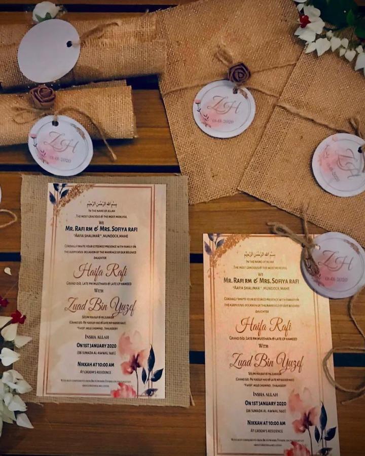 Tan burlap wedding invitation suite from @_doodlingartistry_. Cream cards feature blush florals and twine-tied monogram tags.