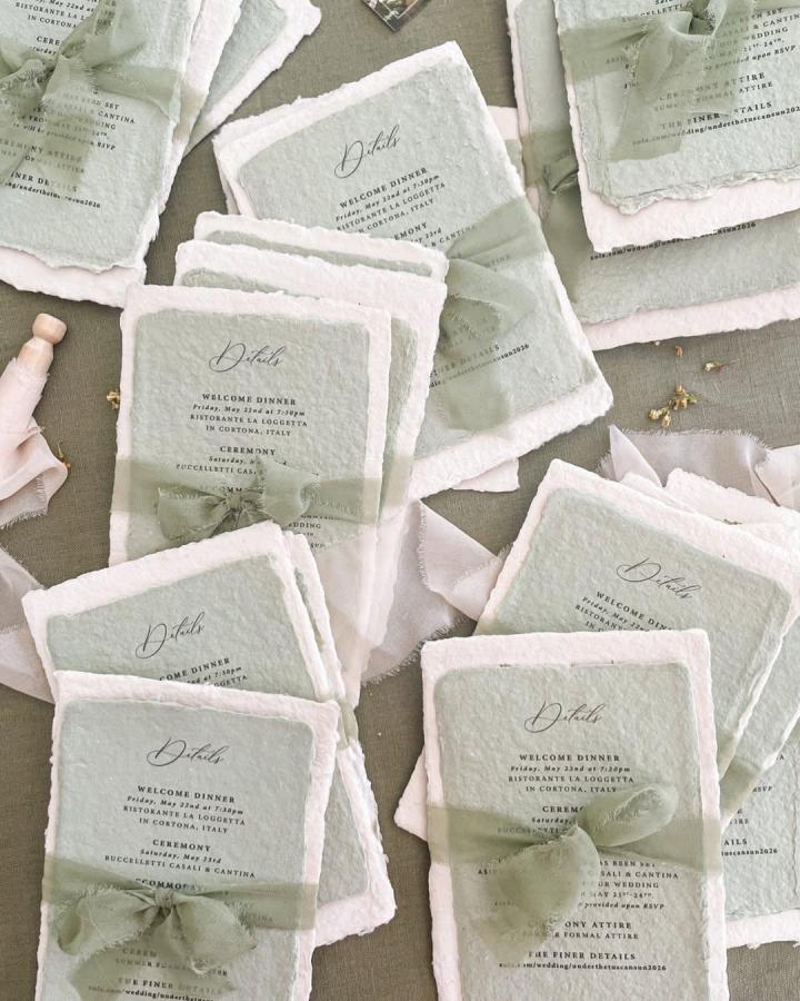 Sage deckled paper invitation suite from @kattonepaper. Translucent ribbon bows soften layered cards.