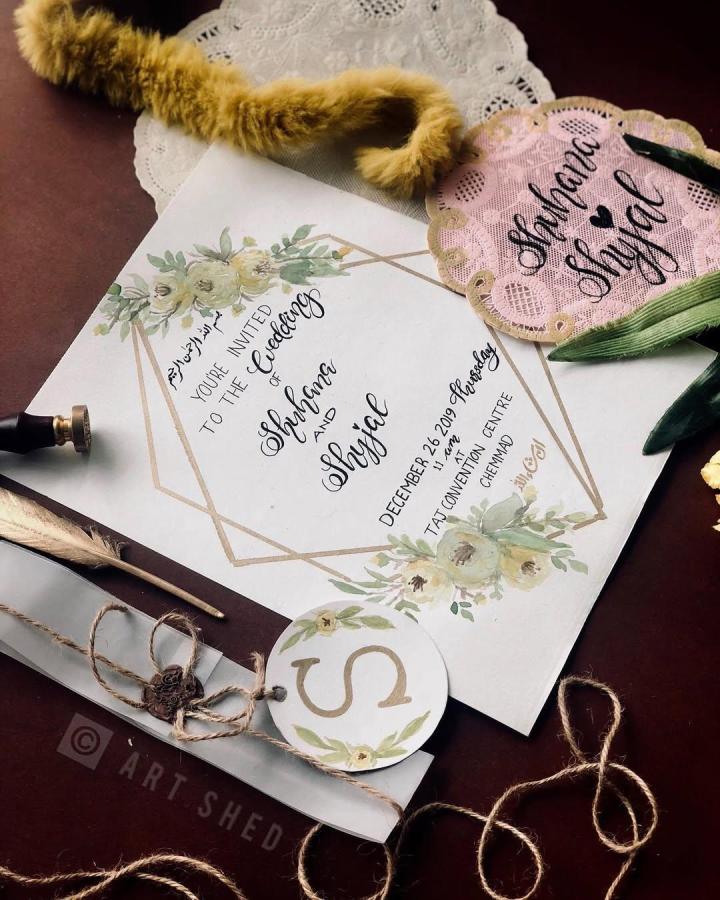 Muted botanical wedding invitation suite from @art_shed_. Watercolor florals, calligraphy, lace heart, twine, and wax seal.