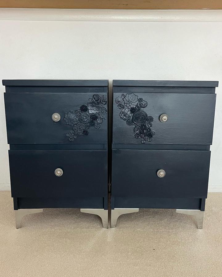 Painted black floral-appliqué bedroom dressers from @941of_a_kind. Repurposed MALM nightstands feature ornate pulls.