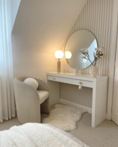White fluted bedroom vanity from @cb_loves_interiors_20. Soft brass handles and round mirror.