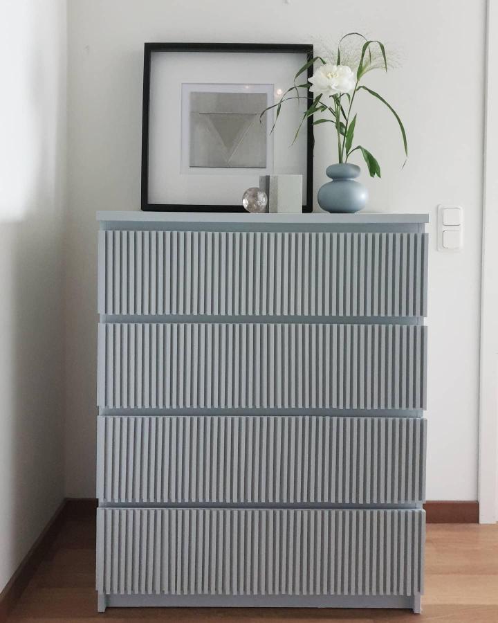 Soft gray fluted Malm dresser from @anahita_poura. Vertical wood details transform this Ikea dresser hack.
