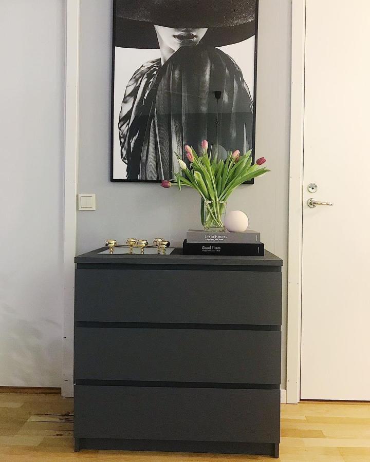 Painted black MALM dresser from @jonnacarlgren. Minimal entryway styling with tulips and framed art.