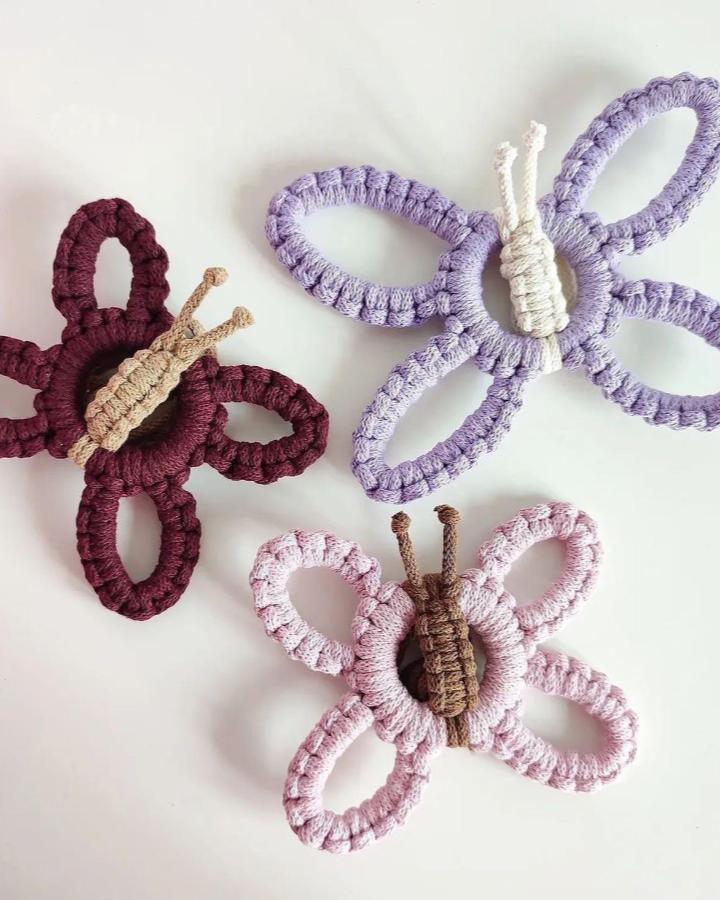 Lilac, burgundy, and pink butterfly macrame animals ideas from @leukedingenloods. Textured cord wings brighten a white wall.