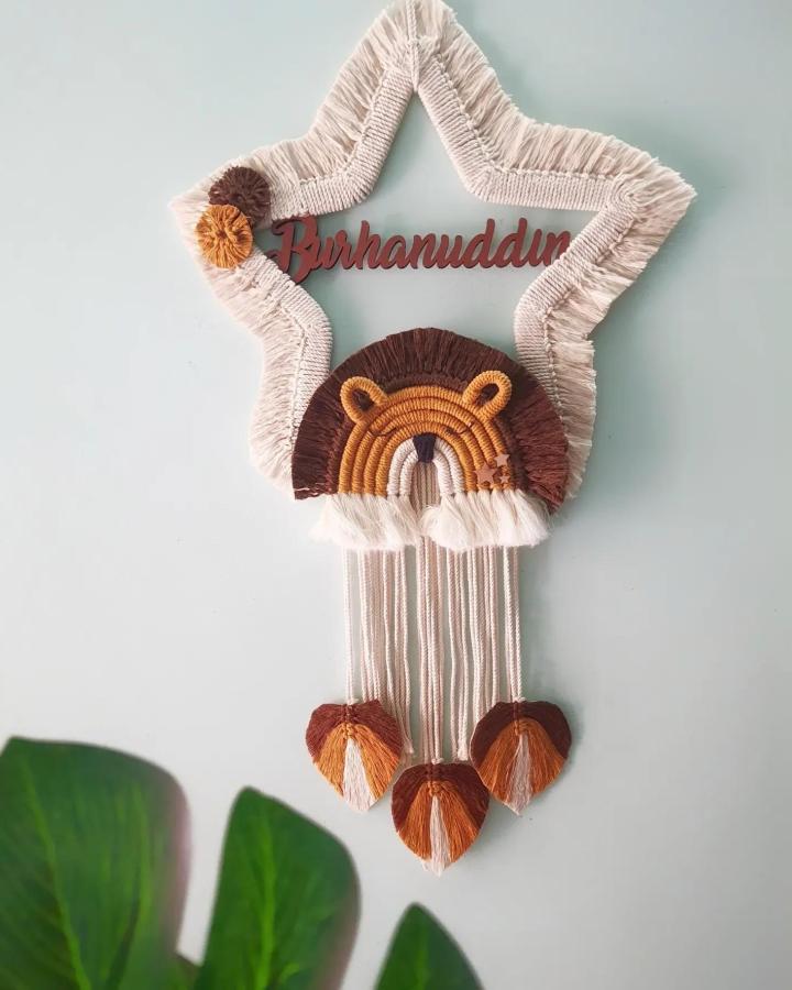 Cream and mustard macrame animals ideas wall hanging from @twist_handmade. Fringed lion beneath a star.