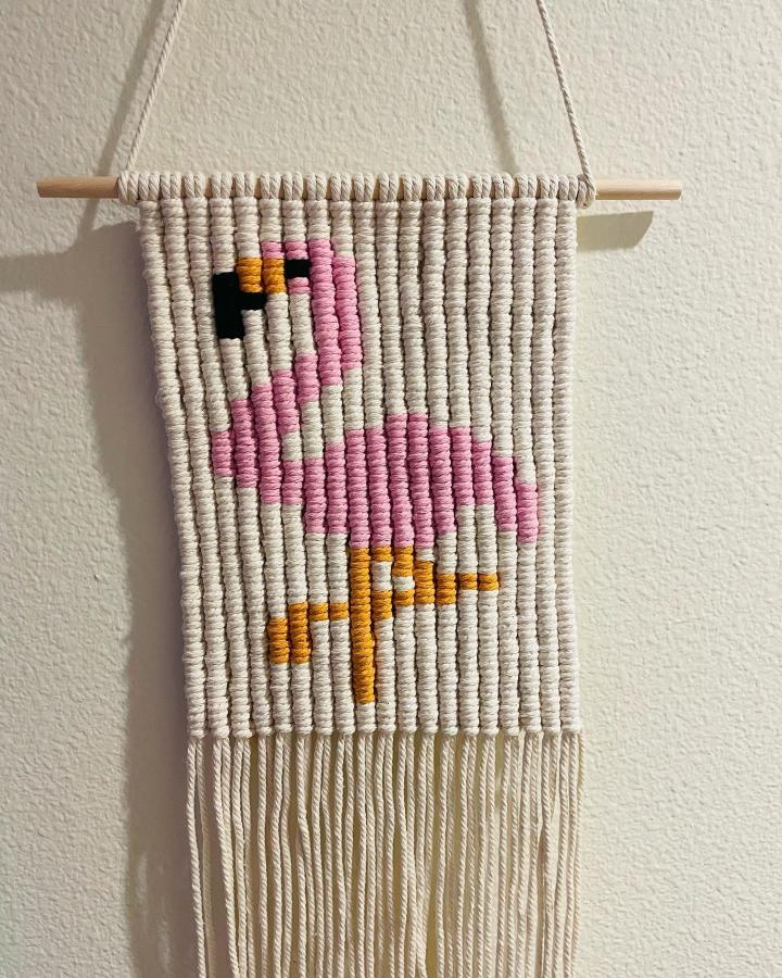Cream-and-pink macrame wall hanging from @entangled.vs. Playful animal design suits macrame animals ideas.