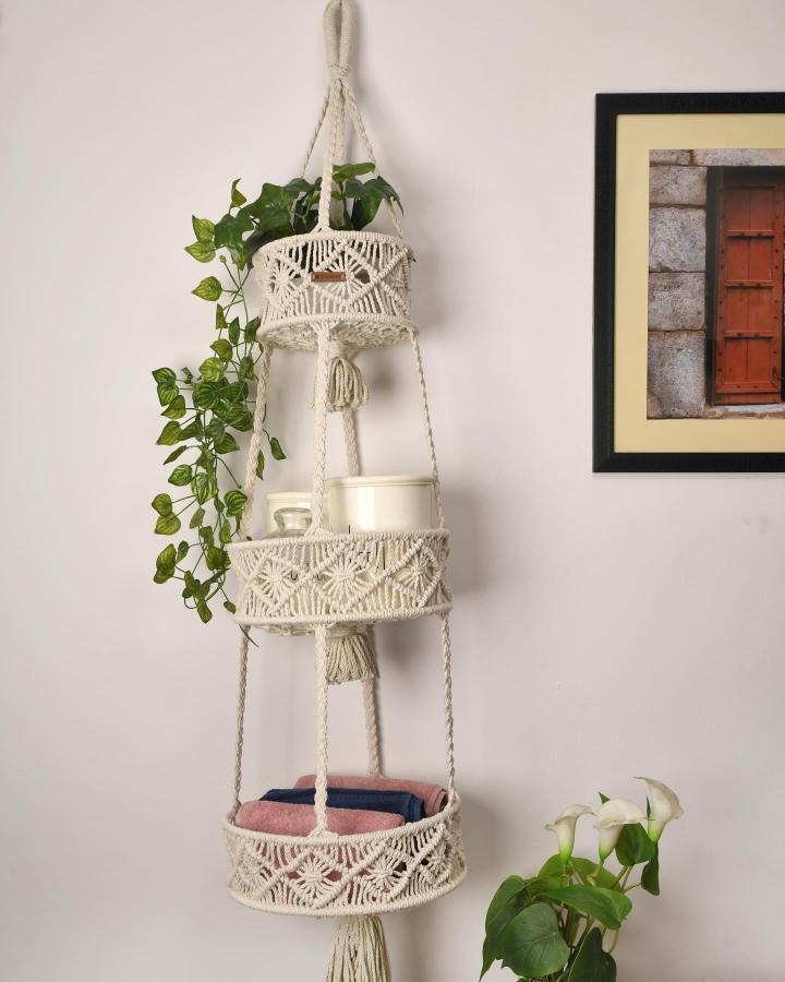 Cream macrame basket ideas hanging organizer from @slaysence_. Three woven tiers hold plants and linens.