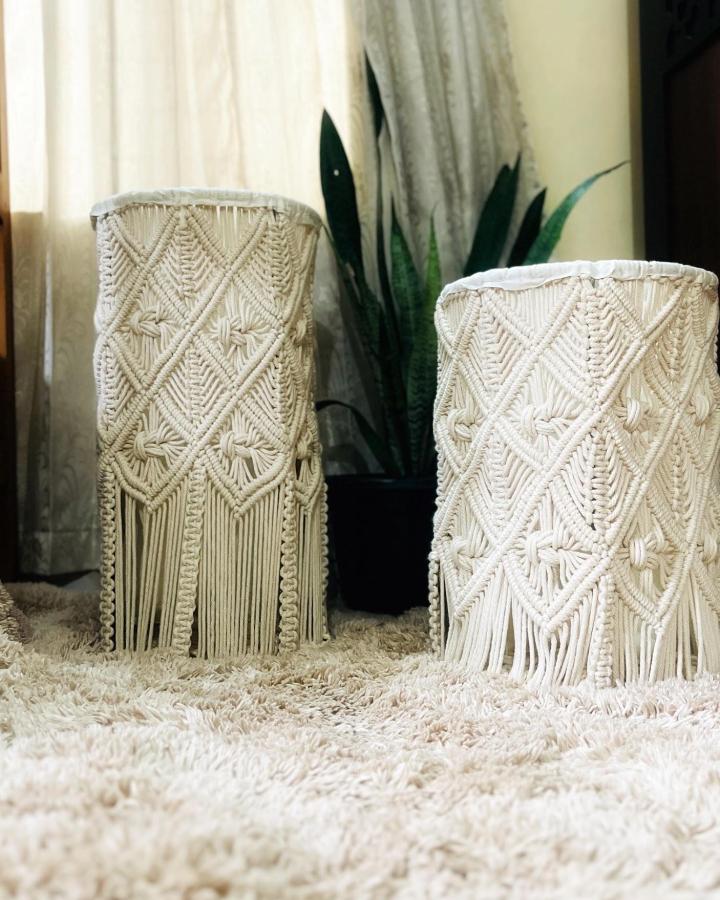 Cream chevron macrame basket display from @ash_knots. Twin woven baskets with fringe and knotted texture.