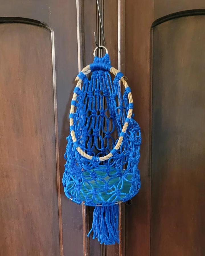 Electric Blue Hanging Macrame Basket from @boho_kansas. Cream rope rim, open knots, and long fringe.