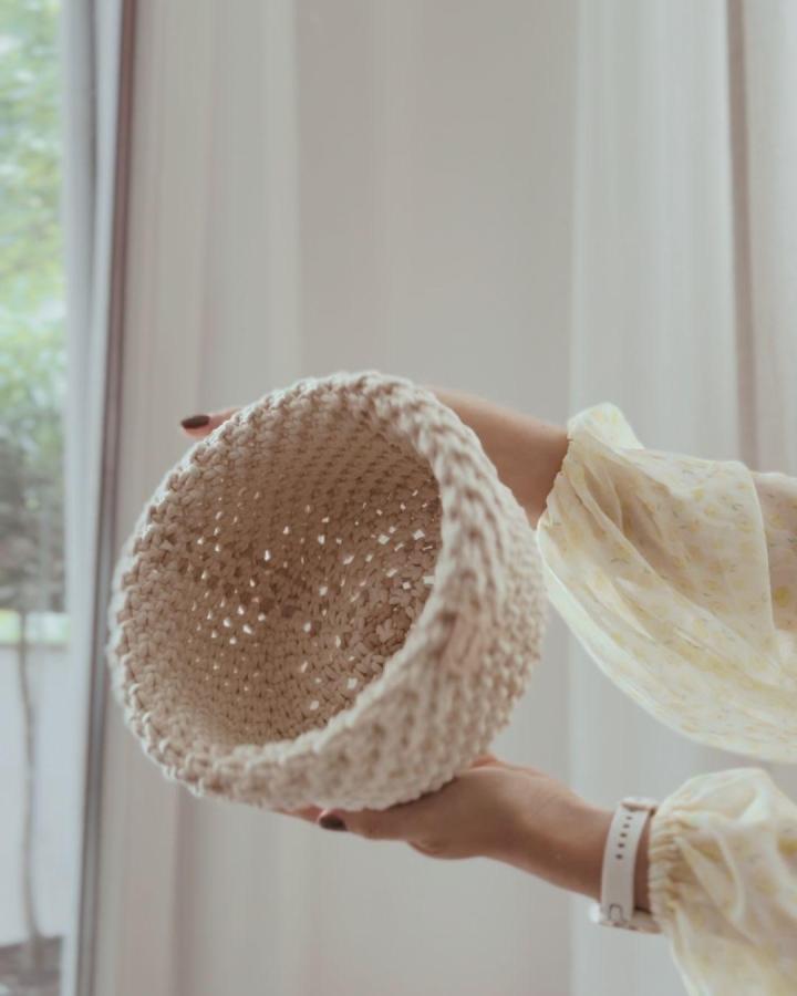 Cream textured macrame basket from @greysmade. Round open weave with a chunky woven rim.