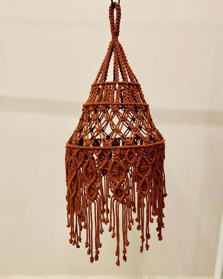 Rust-Brown Macrame Chandelier from @knots_with_macrame. Layered knots and long fringe create a rustic hanging shade.