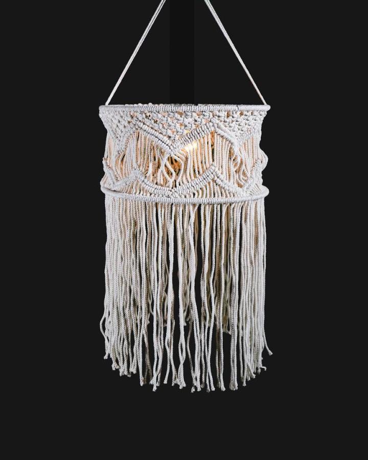 Ivory layered macrame chandelier from @krafdoze. Long fringe and intricate knots create a boho focal point.