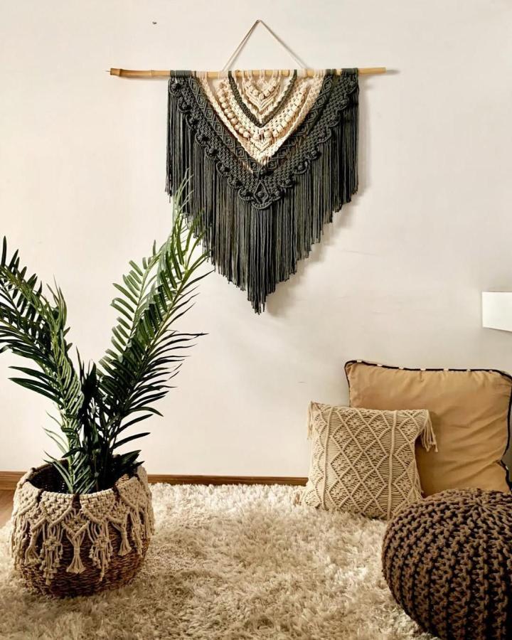 Black And Cream Layered Macrame Wall Art from @terraliving_by_jenita. Textured focal point above a cozy seating area.