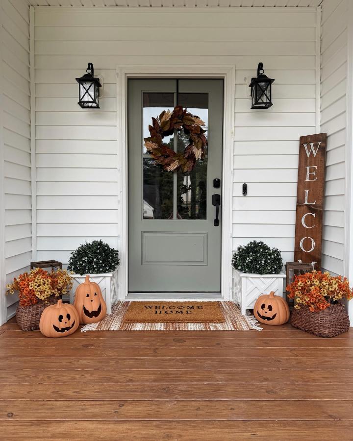 Rustic fall porch from @timberandhive. Small fall porch decor ideas feature pumpkins, wreath, baskets, and a wood welcome sign.