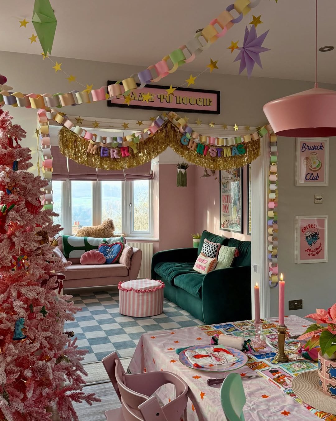 Colorful paper chains and gold stars create apartment christmas decor ideas in a festive pastel living room