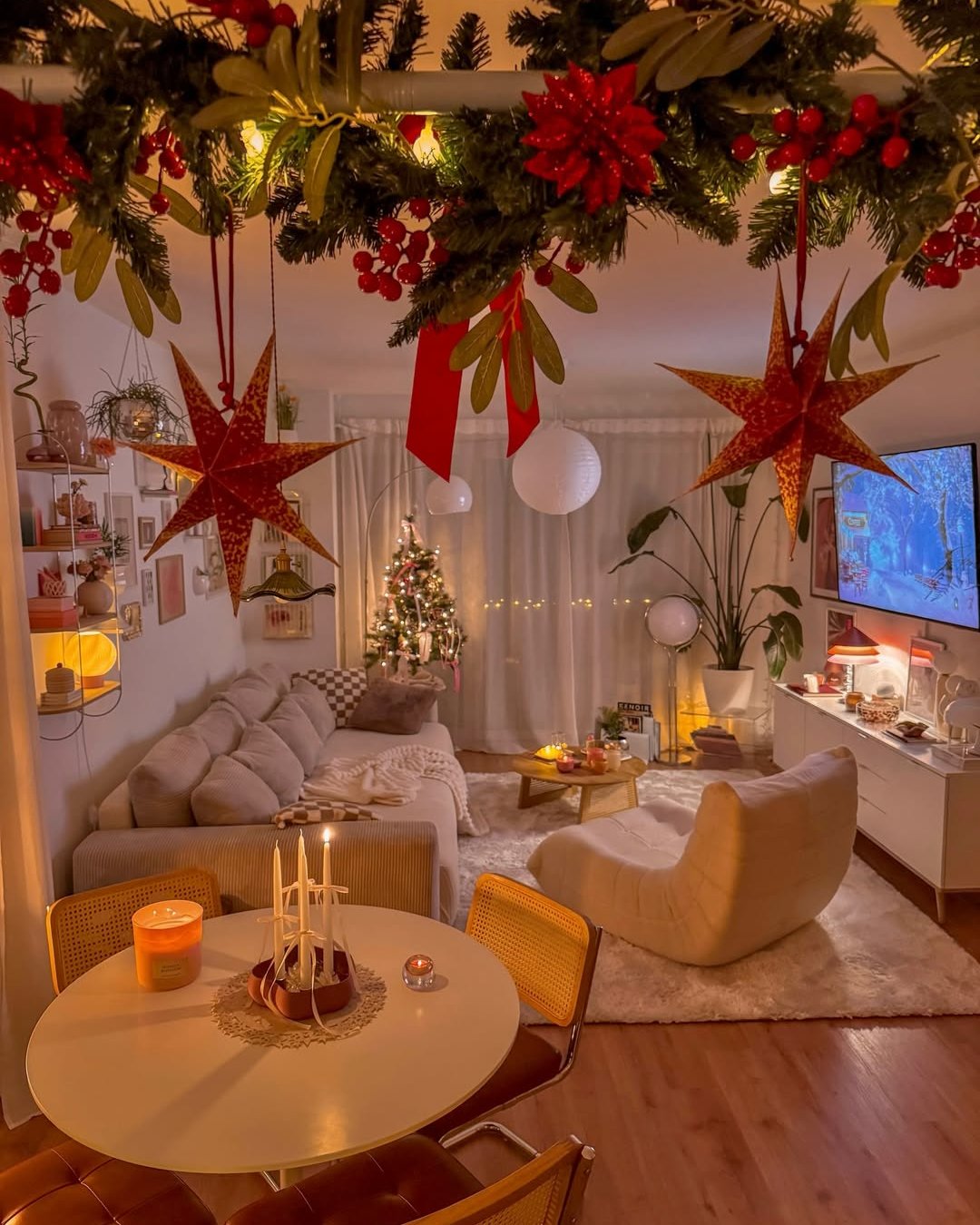 Cozy apartment holiday living room with garland, paper stars, berries, and warm lights