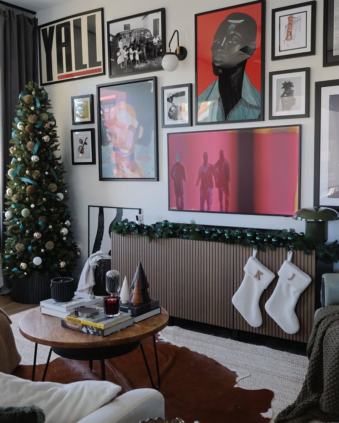 Teal ribbon Christmas tree beside gallery wall and festive mantel garland