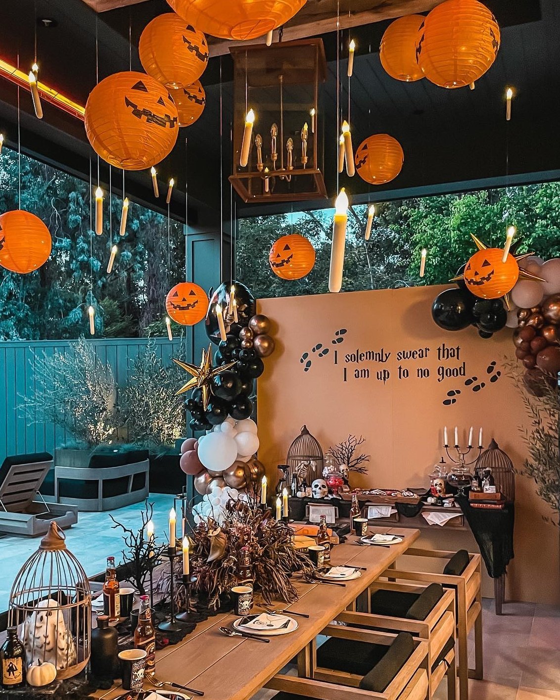 Pumpkin lanterns and candlelit table setting for a spooky outdoor Halloween celebration