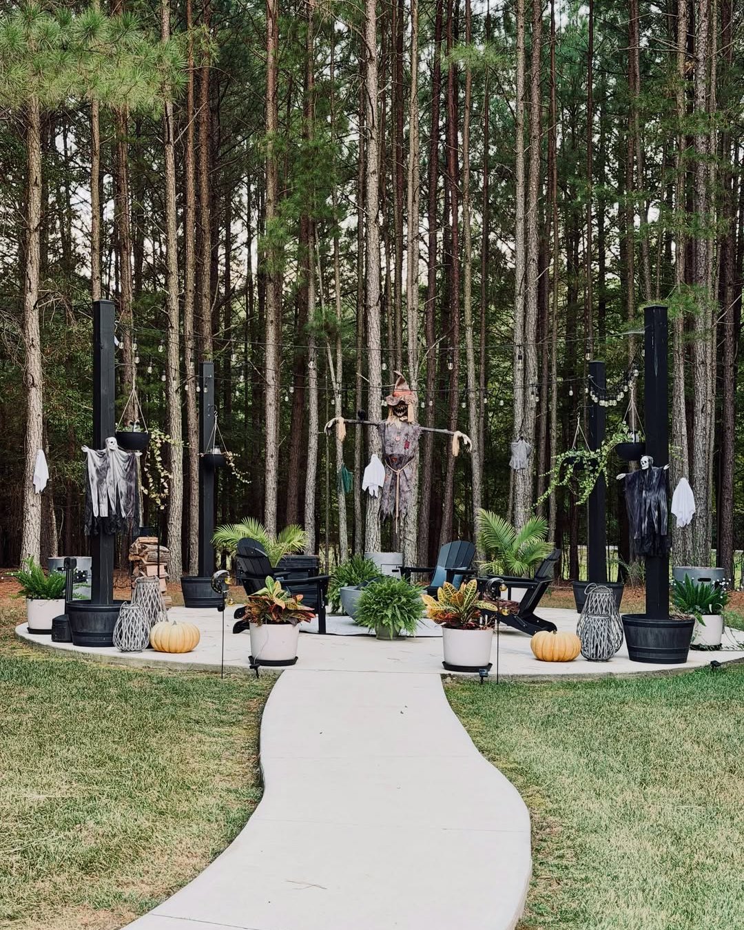 backyard halloween party ideas with ghosts, string lights, pumpkins, and woodland patio decor