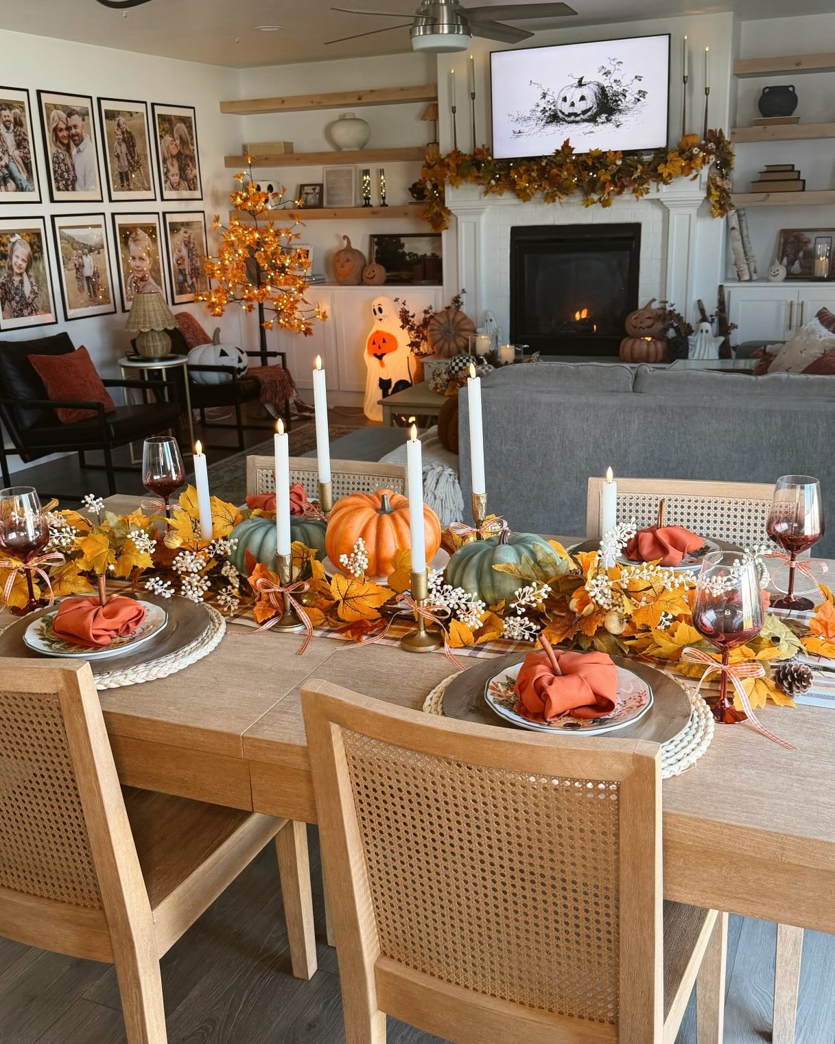 cheap halloween party ideas with autumn leaves, pumpkins, candles, and cozy Halloween table decor