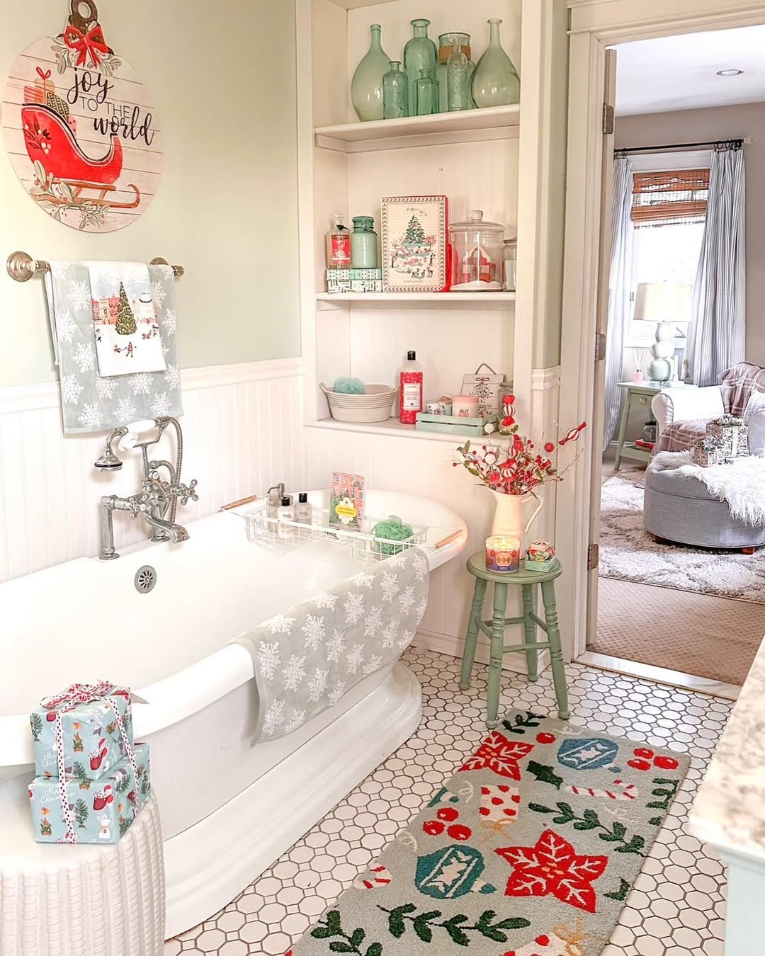 Snowflake towels, festive bath runner, Christmas shelves, red berries, and holiday artwork in a bright bathroom