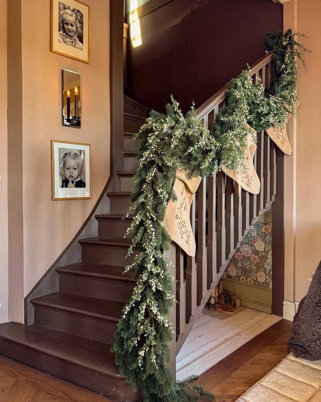 Evergreen staircase garland with white berries and embroidered stockings