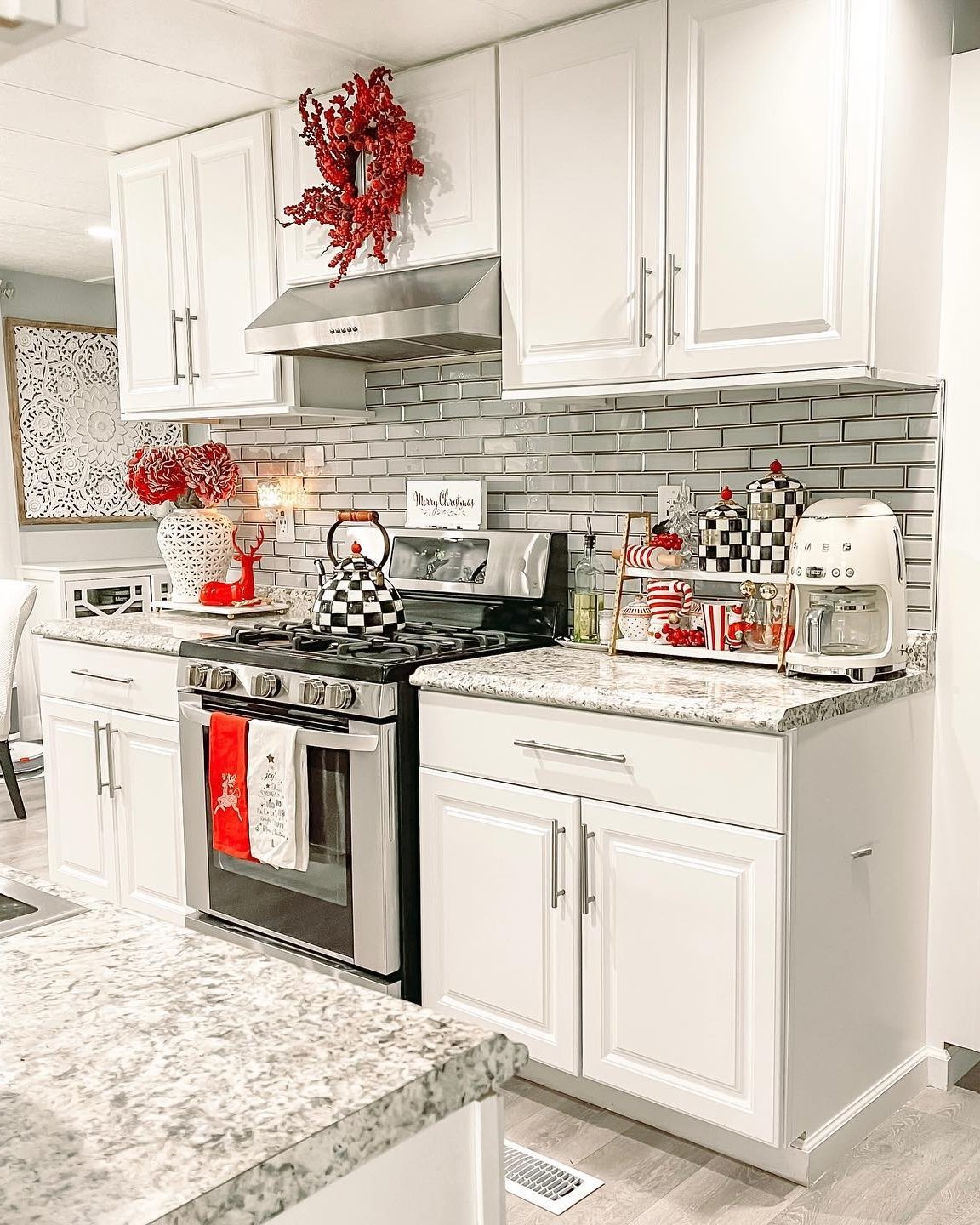 Red wreath, festive red-and-white accents, and Christmas kitchen styling