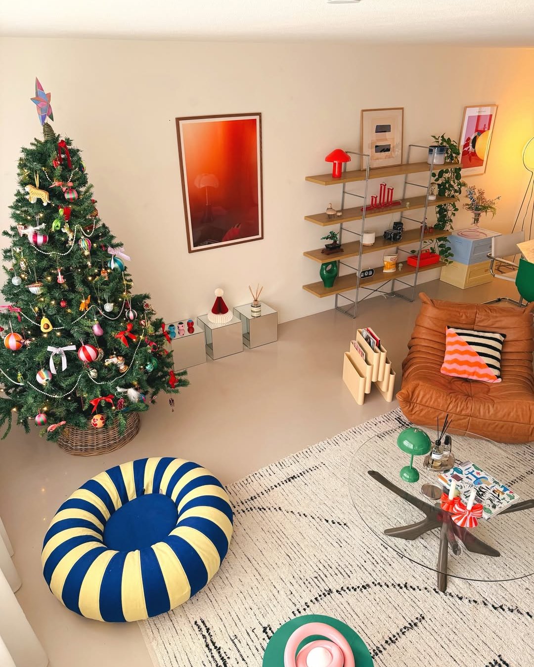 Colorful Christmas tree with playful ornaments beside a modern living room