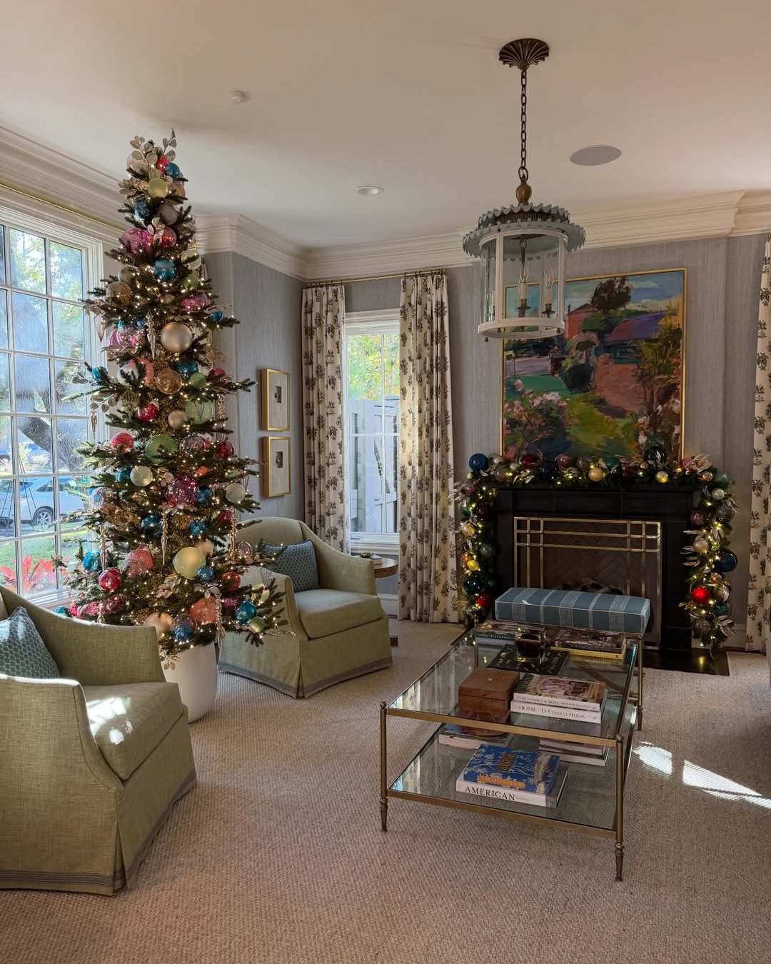 Colorful Christmas tree and glowing mantel garland in an elegant living room