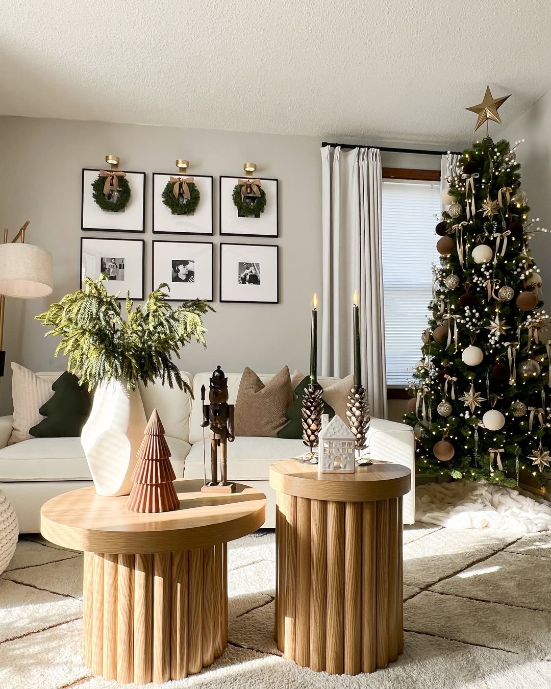 Christmas living room decor ideas with a neutral tree and wreath gallery wall
