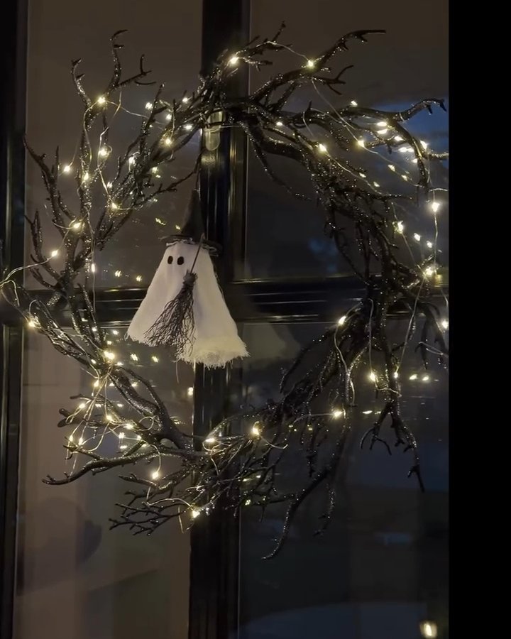 Black twig Halloween wreath with glowing lights and a hanging white ghost