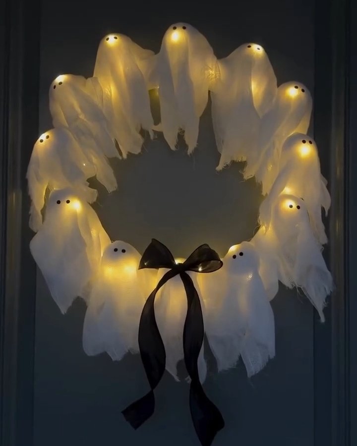 Glowing ghost ring with black bow, a charming handmade Halloween door decoration