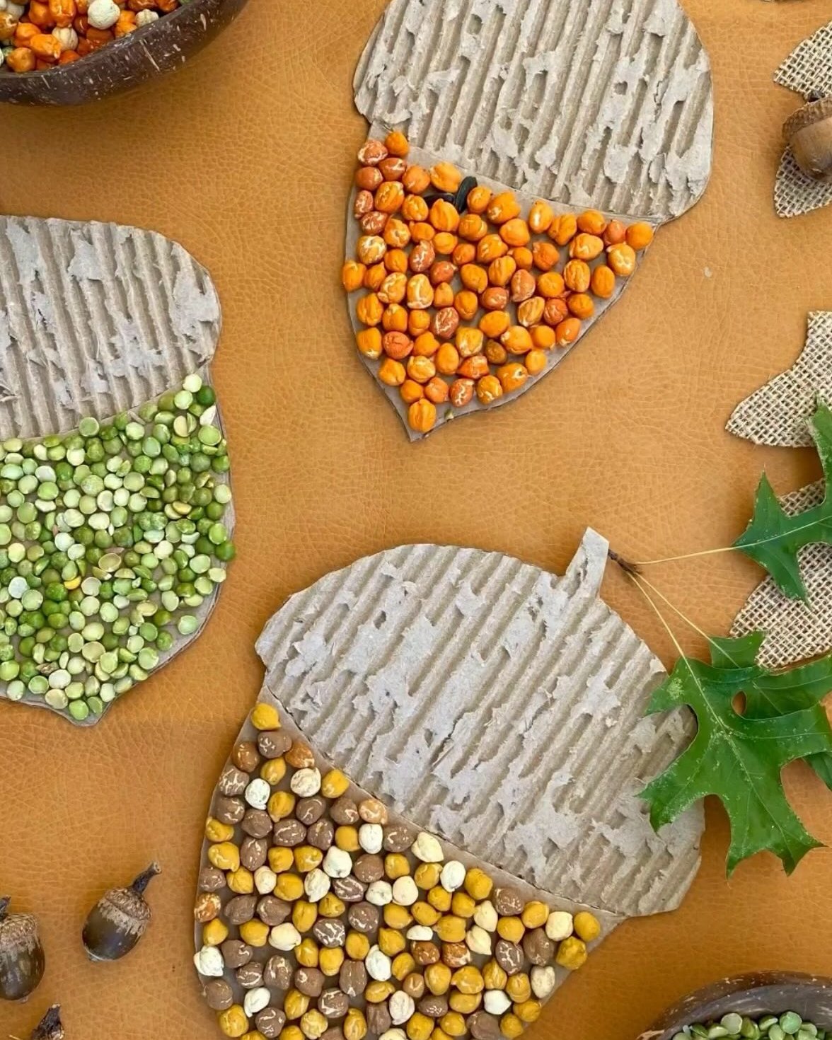 Fall crafts for kids featuring cardboard acorns covered with colorful beans and peas