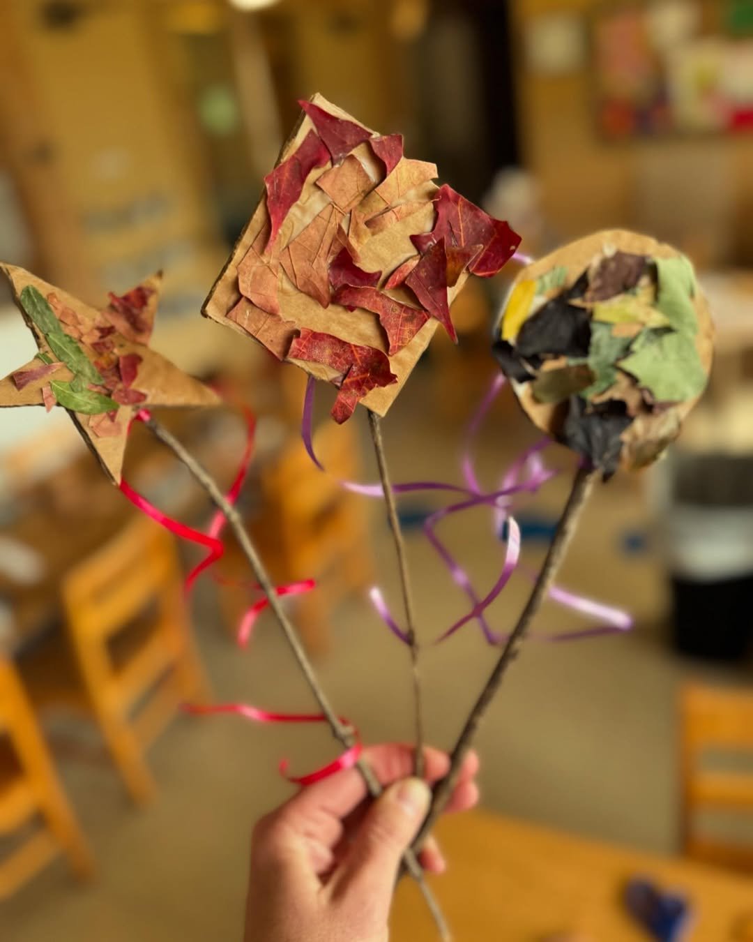 Children's autumn leaf kites with cardboard shapes, twigs, and colorful ribbon tails