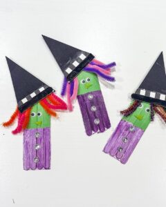 Halloween Crafts for Kids featuring colorful craft stick witch puppets