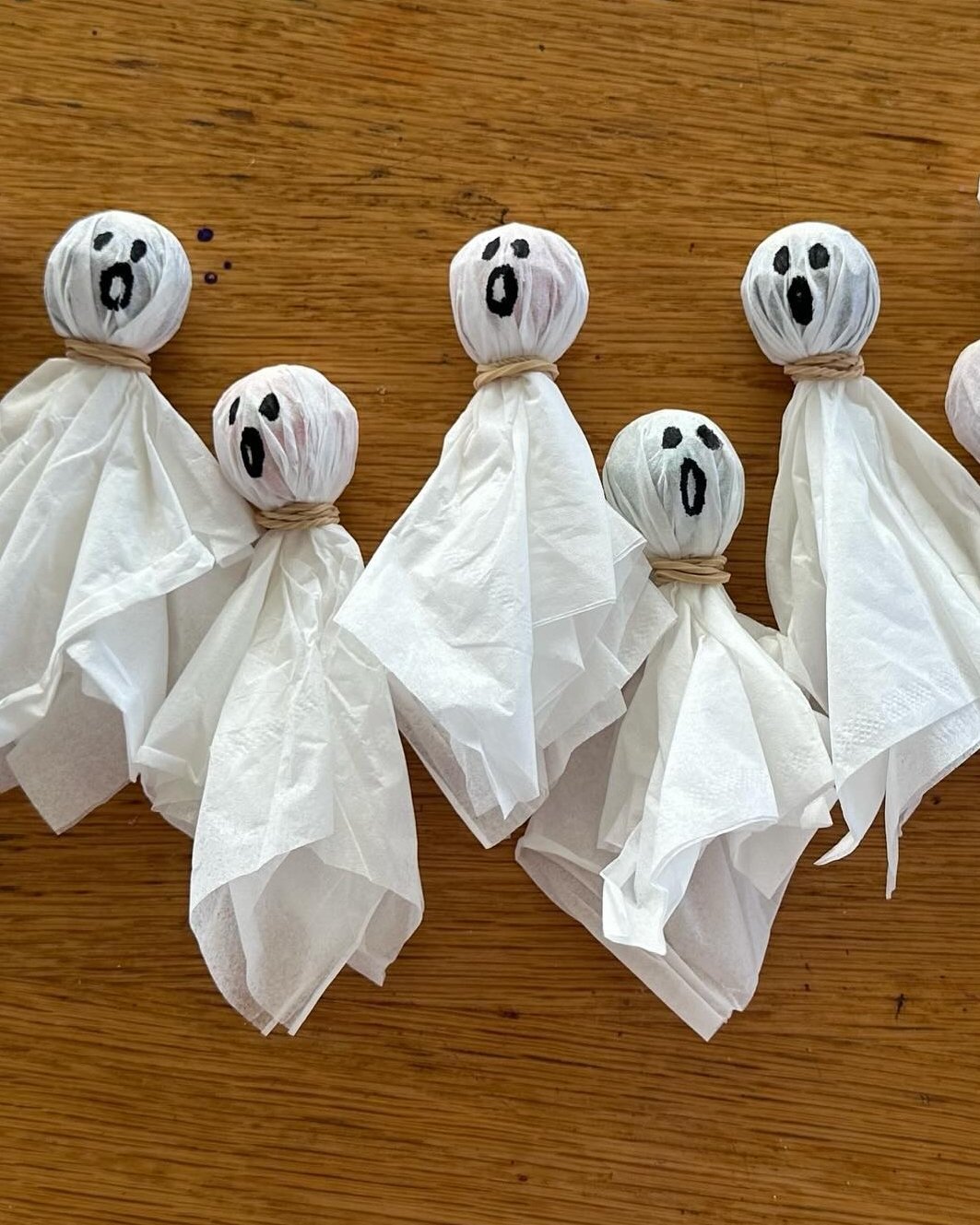 Halloween Crafts for Kids featuring handmade tissue ghosts with spooky faces