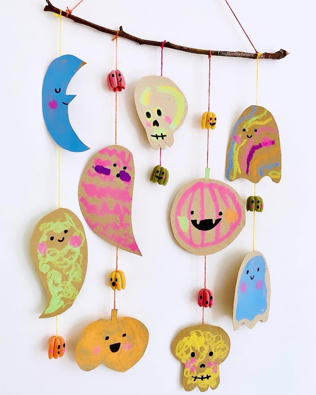 Colorful hanging ghost, pumpkin, skull, and moon mobile for children's Halloween crafts
